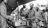 SFC Arnold S. Scales of Richmond, Va., serves steak at the 43rd Transportation Truck Company, 8th U.S. Army, near Uijongbu, Korea, on 18 June 1951. (Photo: Army Quartermaster Museum)